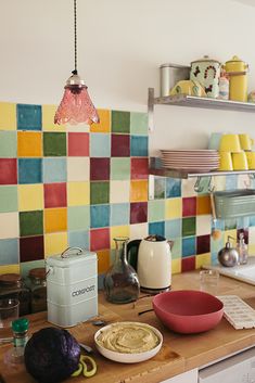 the kitchen counter is covered with colorful tiles