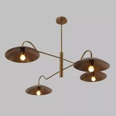 three lights are hanging from the ceiling in an industrial style fixture with metal fittings