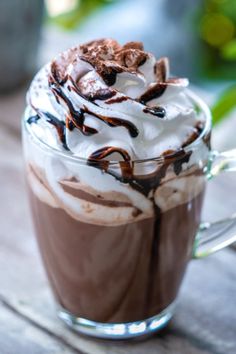 a glass cup filled with chocolate and whipped cream