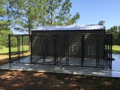 a dog kennel in the middle of a field