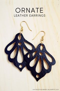 the earrings are made out of black leather and have intricate cutouts on each side