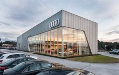 an audi dealership with many cars parked in the lot