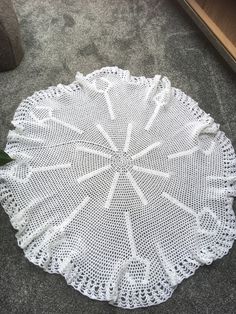 a white crocheted doily on the floor