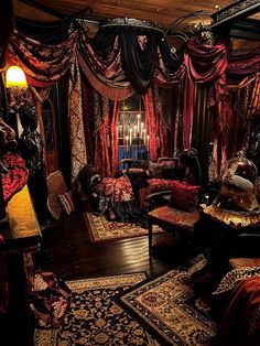 an elaborately decorated bedroom with red and black drapes