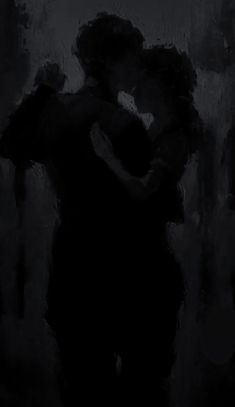 two people are hugging in the dark