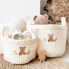 two white baskets with teddy bears on them