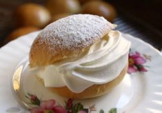 a powdered doughnut with whipped cream on a plate