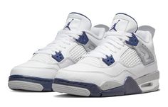 a pair of white and blue sneakers on a white background