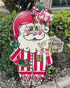 a santa clause sign sitting on the side of a road