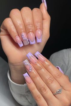 Embrace elegance with these long, coffin-shaped nails boasting a perfect blend of subtlety and sparkle. A soft lilac shade graces the tips, while the nude base creates a classic French manicure look with a twist. Select nails are embellished with a crescent of tiny pearls and glitter, adding a touch of sophisticated glamour ideal for any prom ensemble. Simply stunning! ✨  // Photo Credit: Instagram @nailz.byadii Purple And Champagne Nails, Lilac And White Ombre Nails, Light Lavender French Tip Nails, Repunzel Quince Theme Nails, Long Lilac Nails, Nails Prom Purple, Lilac Nails Simple, Lilac Acrylic Nails Lavender, Gel X Nail Designs Purple