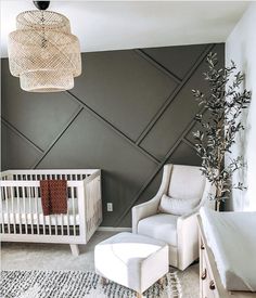 an image of a baby's room with grey walls and white cribs