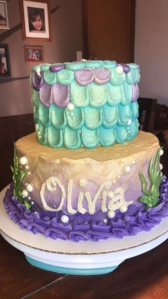 two tiered cake with purple and green icing