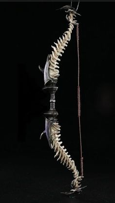 the skeleton of a dragon is displayed in front of a black background