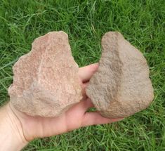 someone is holding two rocks in their hand