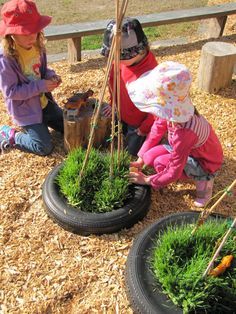 two children are playing with plants in the dirt