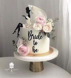 a wedding cake decorated with flowers and the words bride to be