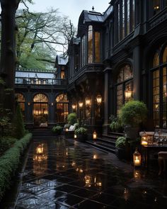 an outdoor courtyard with lit candles and potted plants