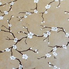 a painting with white flowers and brown leaves on a tan background that is painted in the style of cherry blossoms