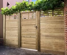 a wooden fence with plants growing over it