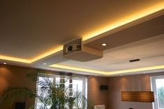 a living room filled with furniture and a flat screen tv mounted to the ceiling over a fire place