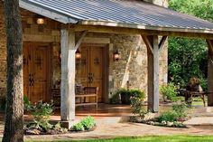 an outdoor patio with chairs and tables under a metal roof covered in wood shingles