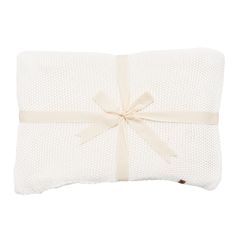 a white pillow with a bow on it