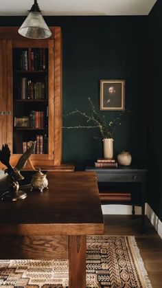 an open book sits on top of a wooden table in front of a bookshelf