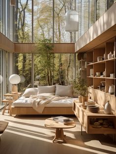 a living room filled with lots of furniture next to tall glass windows on the wall