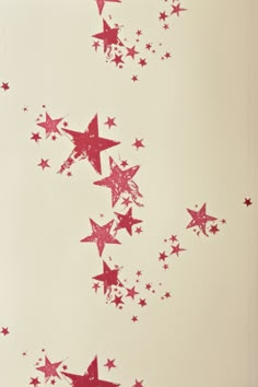 red stars are flying in the air against a white background