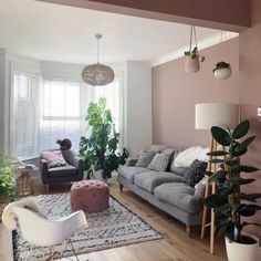 a living room filled with furniture and lots of plants