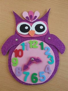 a purple owl clock with numbers on it