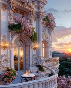 the balcony is decorated with pink flowers and greenery, while the sun sets in the background