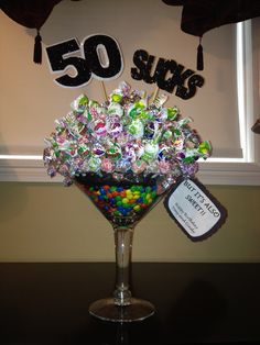 a glass filled with lots of candy sitting on top of a table