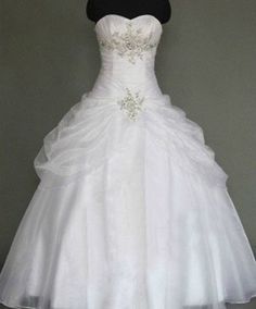 a white wedding dress on a mannequin