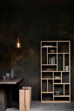 a room with black walls and wooden shelves