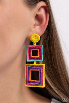 a close up of a person wearing some kind of earring with beads on it