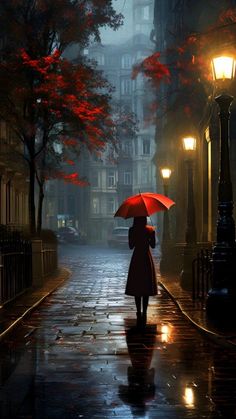 a woman with an umbrella is walking down the street in the rain on a rainy night