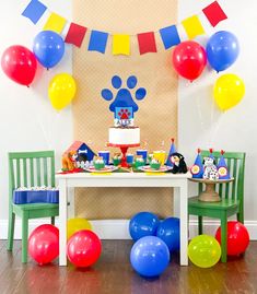 a birthday party with balloons, cake and decorations