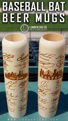 two vases sitting on top of a table with autographed baseball bats in them