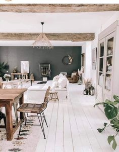 a living room filled with furniture and a wooden table