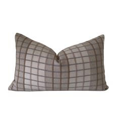 a gray and brown plaid pillow on a white background