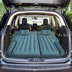 an inflatable bed is placed inside the trunk of a vehicle