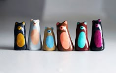 five wooden toy bears lined up in a row