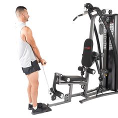 a man standing in front of an exercise machine with a pulley on the side