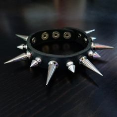 This is a Single Row Punk Bracelet. Punk Ring. Silver Spike. Black Genuine Leather Cuff. Grunge Rock Clasp Buckle Studded Bracelet. Handmade Men Gifts. It's a gift for men or women. This will be a perfect gift for your friends. This product is handmade and takes 1 day to make. It will be shipped as soon as possible on the next day. If you have any questions, please contact us with Etsy message. Free Shipping Over $35. All orders have tracking number. Thank you so much : ) Studded Bracelet, Spike Bracelet, Punk Accessories, Men Gifts, Leather Cuffs, Bracelet Handmade, Ring Silver, Arm Band, Favorite Jewelry