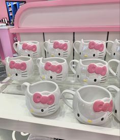 hello kitty mugs are on display in a store