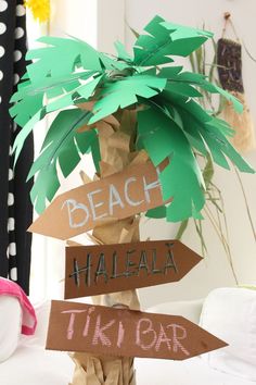 a palm tree made out of paper with signs on it