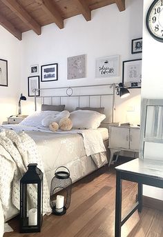 a bedroom with wood floors and white walls