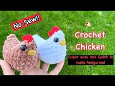 two crocheted chickens are sitting in the grass