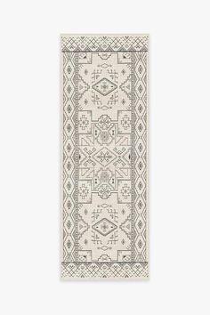 a white rug with an intricate design on the front and back side, in neutral tones